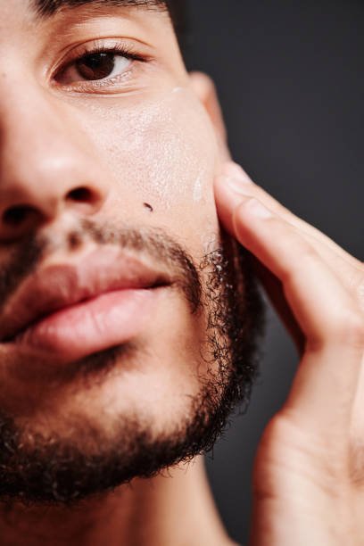 istock Man protecting his face skin with cream 1394532745