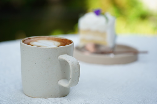 A cup of latte on white table