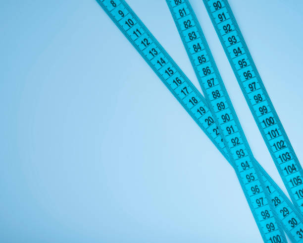 istock Blue tape measure diet concept background with space for text 1394540741