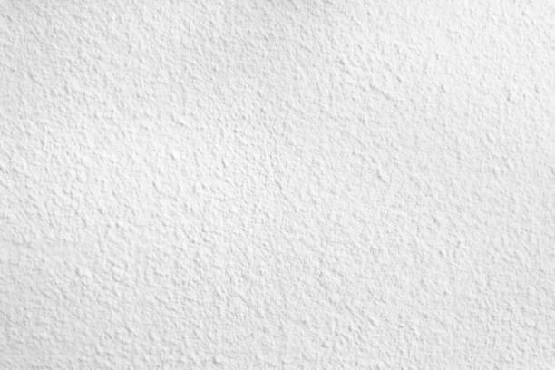 istock Seamless texture of white cement wall a rough surface, with space for text, for a background. 1394542789