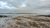 Stream flowing into Balcary Bay, with salmon fishing nets in the background