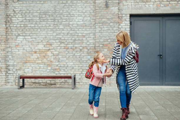 istock Happy smiling kid is going to school for the first time with mom 1394544121