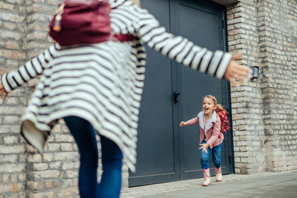 istock Mother and daughter after her classes 1394544792