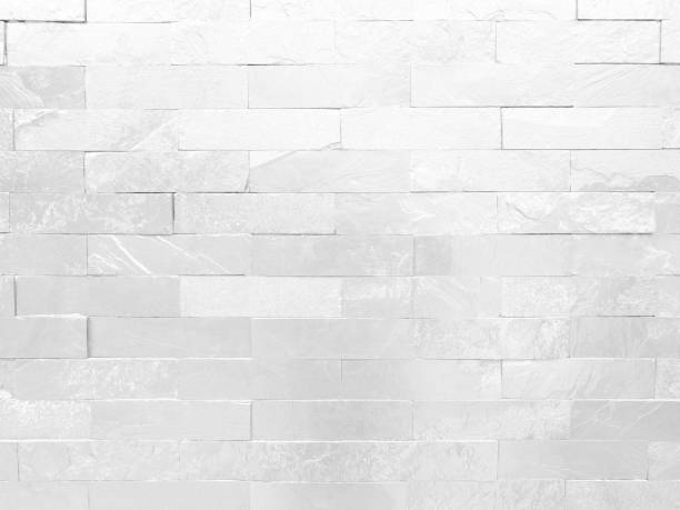 istock Seamless texture of white grey brick stone wall a rough surface, with space for text, for a background.