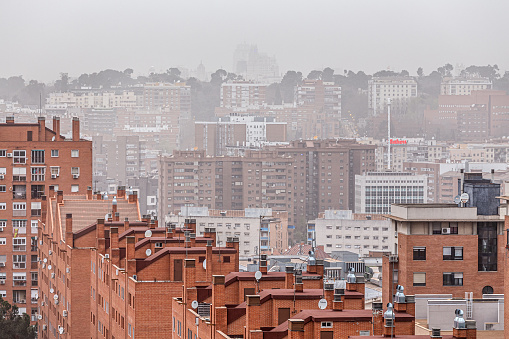 Madrid, Spain. March 15 2022. Residential buildings in Madrid under atmosphere of pollution and desertic dust