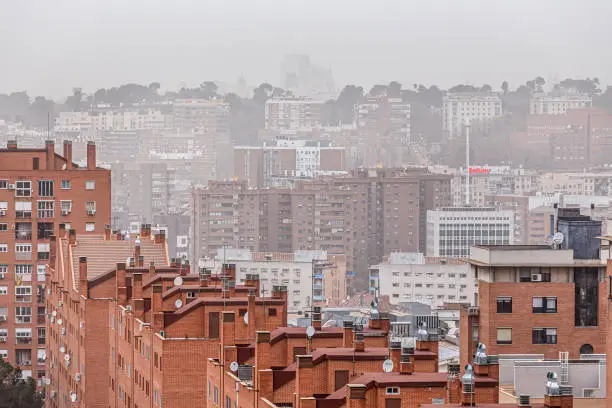 Madrid, Spain. March 15 2022. Residential buildings in Madrid under atmosphere of pollution and desertic dust