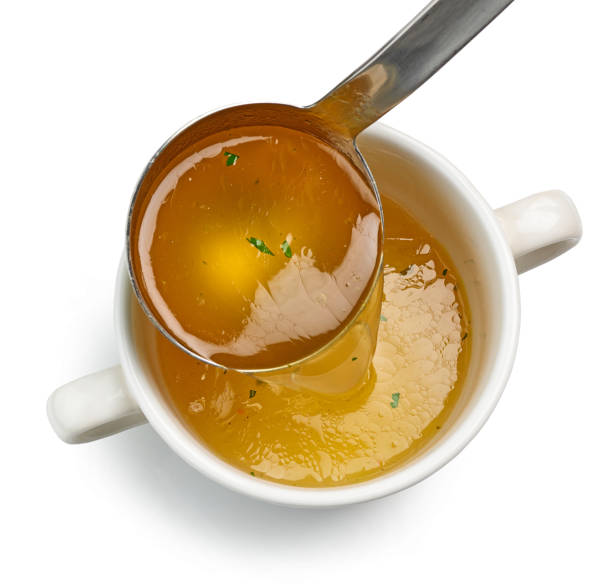 istock chicken broth pouring into bowl 1394548770