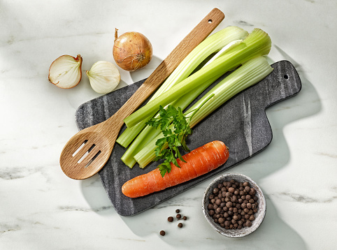 various food ingredients for making broth on kitchen table, top view