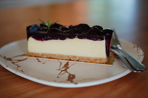 Piece of cheesecake topping with black currant