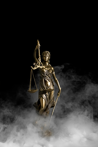Lessons for the future for Law or human rights after the epidemic. Statue of justice on the smoke