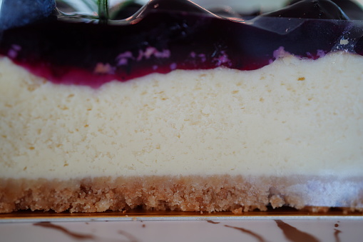 Piece of cheesecake topping with black currant