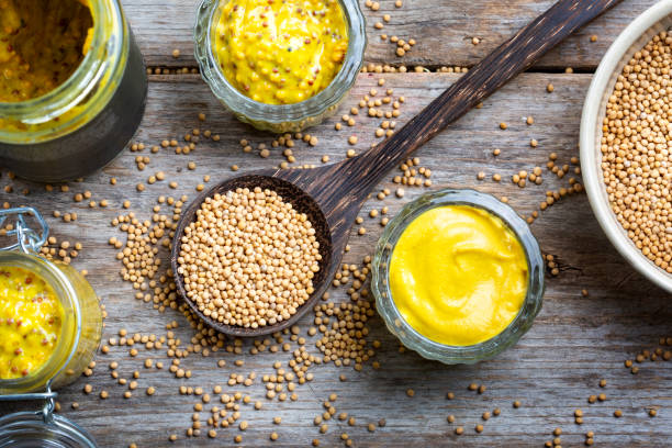istock Different types of mustard and mustard seeds on a rustic wooden board 1394551901