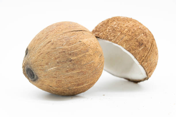 istock Whole coconut and pieces of coconut on white background 1394551926