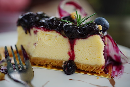Delicious Blueberry Cheesecake Slice on the white plate on table
