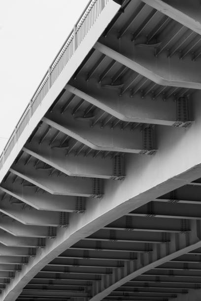 istock Steel bridge span construction, bottom view with gray girders 1394553250
