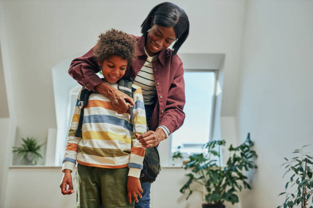 istock Afro mother getting her son ready for school 1394554691