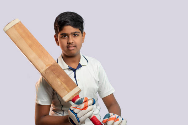 istock A boy in cricket uniform holding Cricket Bat 1394554746