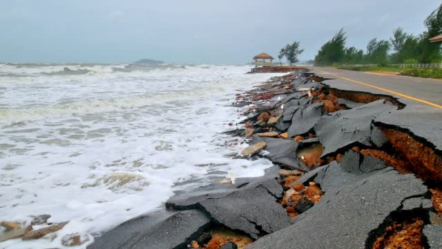Road destroyed by sea water erosion process seaside