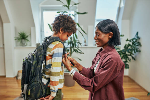istock Mother preparing son for school studies 1394555102