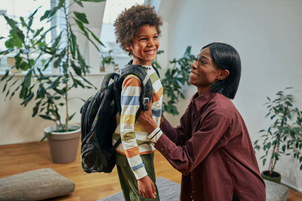 istock Single Mother helping her son get ready for school 1394555222