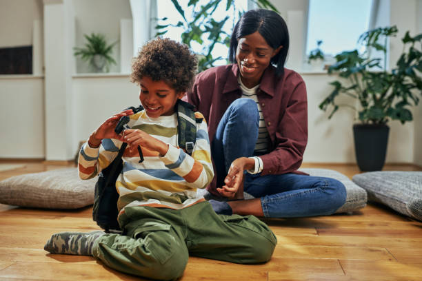 istock Single Mother helping her son get ready for school 1394555260