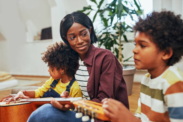 istock Having fun and playing guitar with children 1394556132