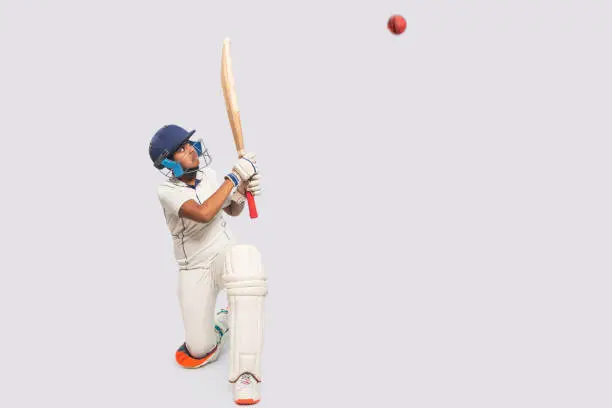 Photo of Portrait of boy hitting a shot  During a Cricket Game