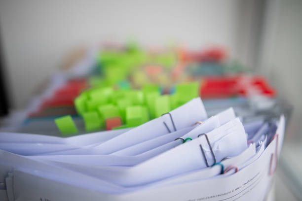istock Pile of unfinished documents on office desk, Stack of business paper 1394557225