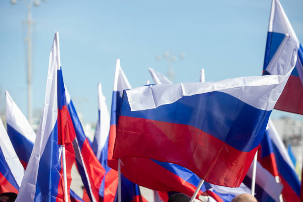 istock Russian flag fluttering on the blue sky background 1394558171