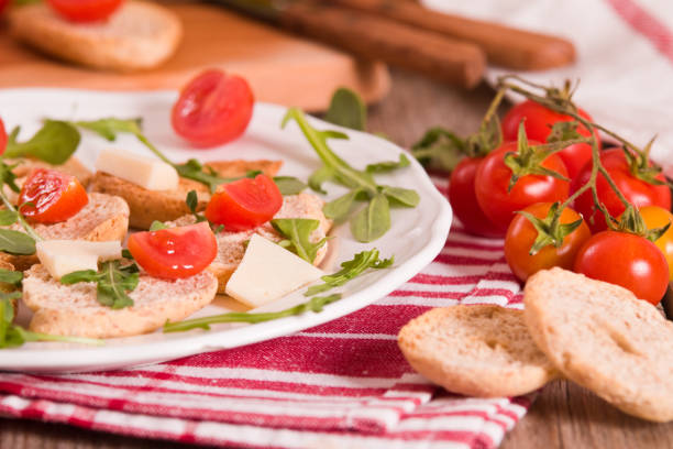 Friselle with cherry tomatoes and arugula.