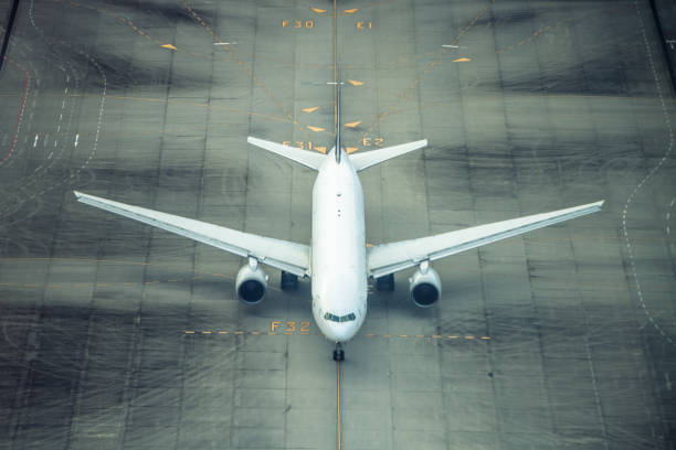 istock Large comercial airplane landing on airport runway 1394561740