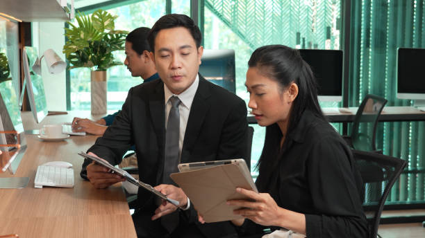 Business team working at office desk, young entrepreneur working with computer, concept of teamwork or company success.