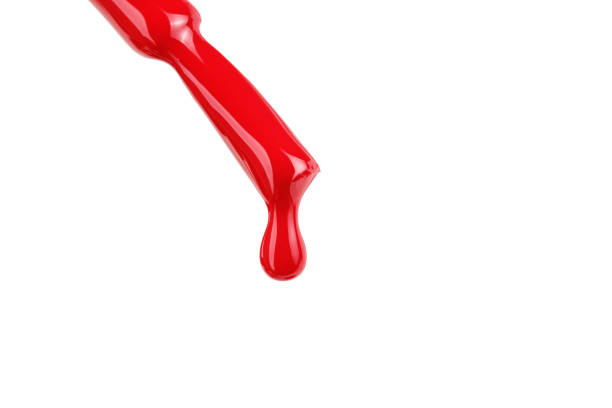 istock Red nail polish brush with drop isolated on white 1394562013