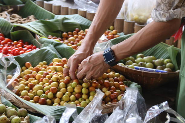 istock Hand of man is selecting Monkey Apples in basket. 1394562852
