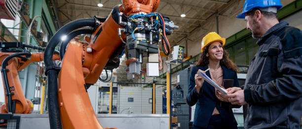 istock Female engineering manager and mechanic worker doing routine check up in industrial factory 1394562896