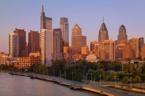 istock Philadelphia Downtown skyline with the Schuylkill river. Beautiful Sunset Light. Schuylkill River Trail in Background. City skyline glows under the beautiful sunset light 1394564725