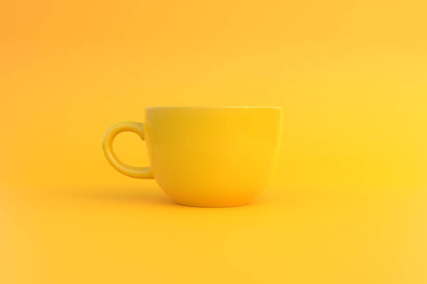 istock Yellow ceramic coffee cup on yellow background 1394566817
