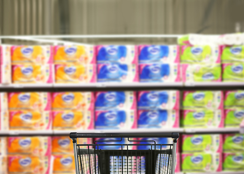 choosing detergents, toilet paper in supermarket.empty grocery cart in an empty supermarket