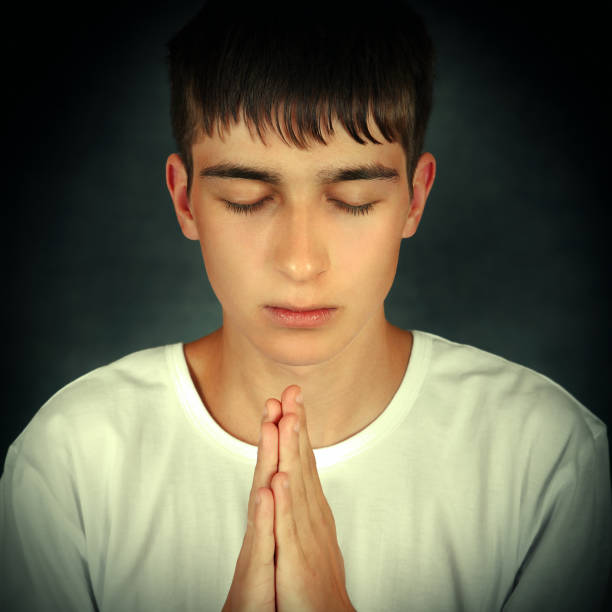 istock Teenager praying 1394571921