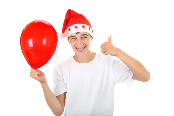 Happy Teenager in Santa's Hat with Red Balloon On The White Background