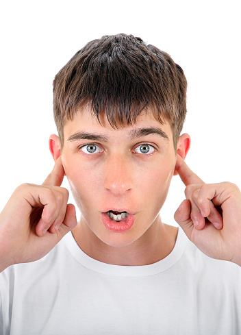 Surprised Teenager Close his Ears with a Fingers Isolated on the White Background