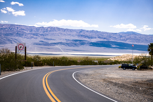 Empty Road in Death Valley, California. Paramint Springs Resort in background.