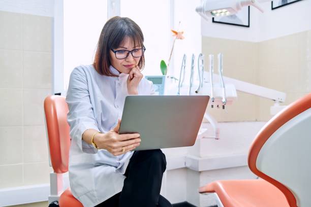 Online consultation, doctor help in clinic using laptop. stock photo
