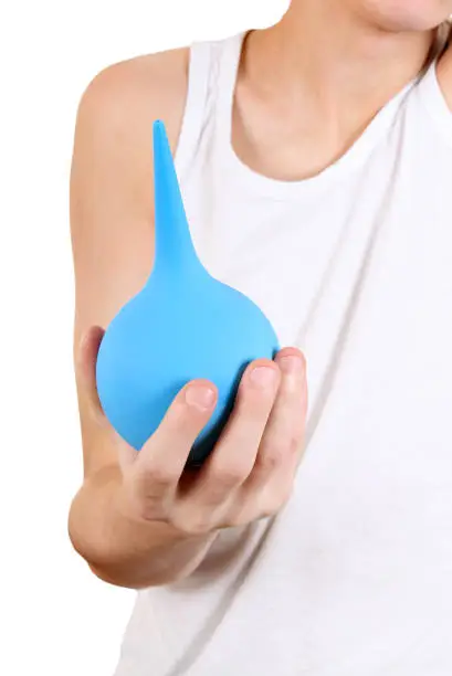 Person holding the Enema in the Hand closeup