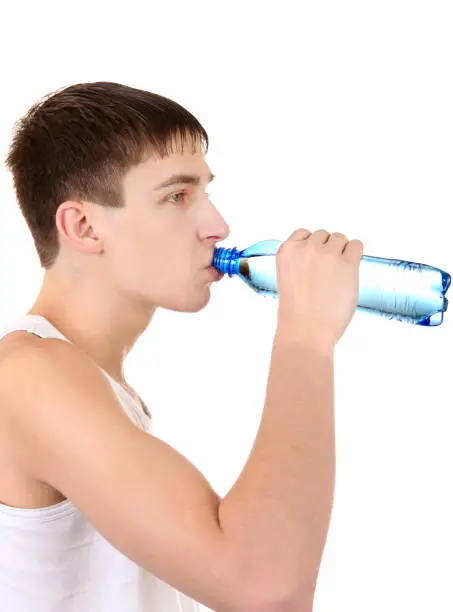 Teenager drinking the Pure Water on the White Background