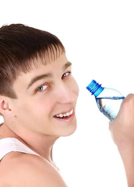 Happy Teenager with Bottle of Water on the White Background