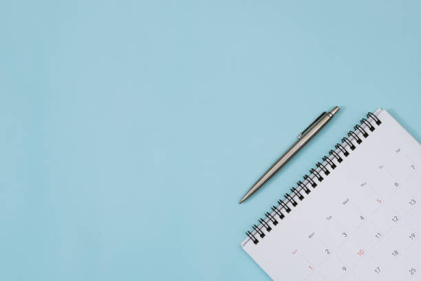 calendar with pen on the blue. empty copy space for text. concept for busy timeline organize schedule,appointment and meeting reminder. planning for business meeting or travel holiday planning concept.
