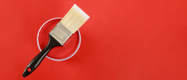 istock The cans of interior wall paint is placed on a red background. 1394595852