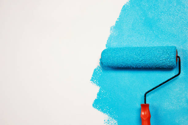 istock Painter is painting the interior wall Blue 1394596069