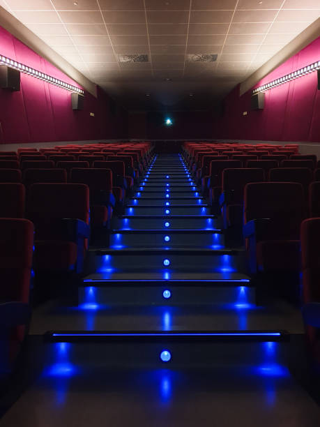 The background of the empty white screen above the stage under the spotlights with purple lighting. Image blurred, focus selective.